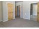 Spacious bedroom with carpeted flooring and wood doors to the hall, closet, and bath at 656 County Road 72, Bailey, CO 80421