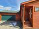 Inviting front entrance with wood-framed windows, an attached garage, and rock landscaping at 656 County Road 72, Bailey, CO 80421