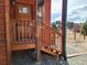 Exterior close-up of the front door and porch, featuring wood steps and gravel landscaping at 656 County Road 72, Bailey, CO 80421