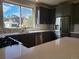 Modern kitchen with stainless steel appliances, gray cabinetry, and a large bright window at 656 County Road 72, Bailey, CO 80421
