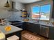 Modern kitchen with stainless steel appliances, stone countertops, and a mountain view at 656 County Road 72, Bailey, CO 80421