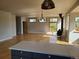 Bright living room with wood floors, many windows, and a wood burning stove at 656 County Road 72, Bailey, CO 80421