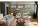 Bright living room featuring large windows, hardwood floors, and comfortable seating at 656 County Road 72, Bailey, CO 80421