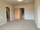 Living room with carpeted flooring and a wood door to a stairwell at 656 County Road 72, Bailey, CO 80421
