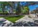 Professionally landscaped backyard with artificial turf, stone accents and a stamped concrete pathway at 5672 S Hanover Way, Greenwood Village, CO 80111