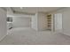 Spacious basement area featuring neutral carpet, white walls, and built-in shelving for versatile use at 5672 S Hanover Way, Greenwood Village, CO 80111