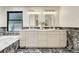 Well-lit bathroom featuring double vanity, marble accents, and modern fixtures at 5672 S Hanover Way, Greenwood Village, CO 80111