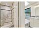Elegant bathroom featuring a glass enclosed shower with marble tile surround at 5672 S Hanover Way, Greenwood Village, CO 80111