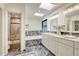 Bright bathroom showcasing a double vanity, soaking tub, and separate glass enclosed shower at 5672 S Hanover Way, Greenwood Village, CO 80111