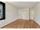 Spacious bedroom featuring hardwood flooring, closet and a large window at 5672 S Hanover Way, Greenwood Village, CO 80111