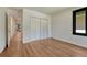 Clean bedroom featuring hardwood flooring, bi-fold closet and an ensuite bathroom at 5672 S Hanover Way, Greenwood Village, CO 80111