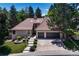 Charming home with a terracotta tile roof, an attached two car garage, and mature landscaping at 5672 S Hanover Way, Greenwood Village, CO 80111