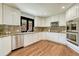 Well-lit kitchen with stainless steel appliances, granite countertops, and hardwood floors at 5672 S Hanover Way, Greenwood Village, CO 80111