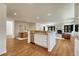 Open kitchen and dining area with granite countertops, stainless steel appliances, and hardwood floors at 5672 S Hanover Way, Greenwood Village, CO 80111