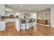 Modern kitchen open to dining area and breakfast bar with seating at 5672 S Hanover Way, Greenwood Village, CO 80111