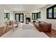 Open-concept living room features a fireplace, hardwood floors, and plenty of natural light at 5672 S Hanover Way, Greenwood Village, CO 80111