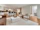 Open-concept living room with eat-in kitchen, hardwood floors, and modern furniture at 5672 S Hanover Way, Greenwood Village, CO 80111