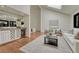 Living room view with bar, fireplace, skylight, and hardwood floors at 5672 S Hanover Way, Greenwood Village, CO 80111