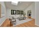 Comfortable living room with hardwood floors, skylight, and fireplace in the background at 5672 S Hanover Way, Greenwood Village, CO 80111