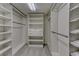 Organized walk-in closet with built-in shelving, drawers, and ample hanging space for optimal storage at 5672 S Hanover Way, Greenwood Village, CO 80111