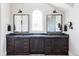 Modern bathroom with dark wood cabinets and marble countertops at 9356 Cherrywood Trl, Littleton, CO 80127
