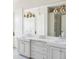 Elegant bathroom with double vanity, quartz countertop, and gold fixtures at 9356 Cherrywood Trl, Littleton, CO 80127
