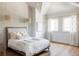 Bright bedroom with white walls, wood floors, and a cozy bed at 9356 Cherrywood Trl, Littleton, CO 80127