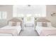 Twin bedroom with two beds, window seat, and mountain views at 9356 Cherrywood Trl, Littleton, CO 80127