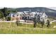 Expansive luxury home boasting stone accents, neutral paint, three-car garage, and mountain views at 9356 Cherrywood Trl, Littleton, CO 80127