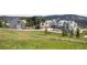 Wide angle view of expansive property with modern luxury home and barn in a meadow setting at 9356 Cherrywood Trl, Littleton, CO 80127
