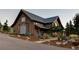 Rustic barn-style home with landscaping and driveway at 9356 Cherrywood Trl, Littleton, CO 80127