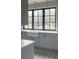 Modern kitchen features farmhouse sink, custom cabinetry and designer flooring at 9356 Cherrywood Trl, Littleton, CO 80127