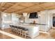 Gourmet kitchen with large island, custom cabinetry, and wood beams at 9356 Cherrywood Trl, Littleton, CO 80127