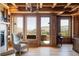 Wood-paneled library with built-in shelves and mountain views at 9356 Cherrywood Trl, Littleton, CO 80127
