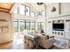 Spacious living room boasts vaulted ceilings, large windows, and ample natural light at 9356 Cherrywood Trl, Littleton, CO 80127