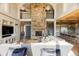 Two-story living room with floor-to-ceiling stone fireplace at 9356 Cherrywood Trl, Littleton, CO 80127