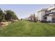 Expansive, beautifully landscaped yard with stone retaining wall and mature trees at 9356 Cherrywood Trl, Littleton, CO 80127