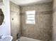 Bathroom featuring neutral tile shower, window and updated fixtures at 3798 S Grant St, Englewood, CO 80113