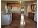 Functional kitchen featuring wood cabinets, laminate floors, and a full-size refrigerator at 3798 S Grant St, Englewood, CO 80113