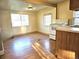 Kitchen with bright dining area featuring wood floors and a white range at 3798 S Grant St, Englewood, CO 80113