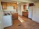 Charming kitchen with light fixtures, laminate flooring, and standard appliances at 3798 S Grant St, Englewood, CO 80113