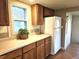 Classic kitchen area with wooden cabinets, bright countertops, and a modern refrigerator at 3798 S Grant St, Englewood, CO 80113
