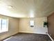 Bright living room featuring plush carpeting, neutral walls, and natural light from the large windows at 3798 S Grant St, Englewood, CO 80113