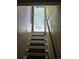 Stairway leading to an open doorway with natural light and outdoor views at 3798 S Grant St, Englewood, CO 80113