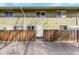 Up close view of exterior unit entrance featuring a privacy fence and vertical wood paneling at 9925 W 20Th Ave # 17, Lakewood, CO 80215