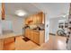 Well-lit kitchen with light wood cabinets, stainless steel dishwasher, and breakfast nook at 9925 W 20Th Ave # 17, Lakewood, CO 80215