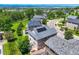 Aerial view of house with solar panels, green trees, and manicured lawns at 3508 E 140Th Pl, Thornton, CO 80602