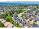 Wide aerial view of community and landscape with lush green trees and a clear blue sky at 3508 E 140Th Pl, Thornton, CO 80602