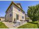 Exterior view of the home featuring siding, windows, a small patio, and backyard at 3508 E 140Th Pl, Thornton, CO 80602
