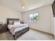 Bedroom boasts a cozy gray bed frame, plush carpet, and natural light at 3508 E 140Th Pl, Thornton, CO 80602